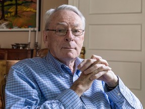 Dick Pound sits with his fingers interlaced
