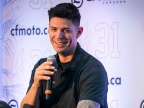 Carey Price laughs while speaking in a microphone during a promotional event
