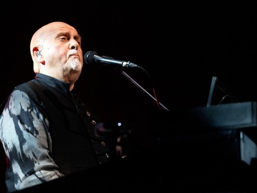 Closeup side profile of Peter Gabriel performing.