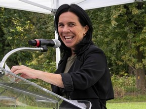 Montreal Mayor Valérie Plante is smiles from the podium while holding a press conference.
