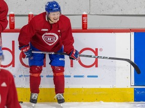 Canadiens prospect Emil Heineman is seen hunched over near the boards during practice.
