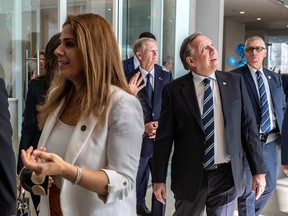 Premier Francois Legault tours Montreal’s new HEC campus on Friday, Sept. 15, 2023. Higher Education Minister Pascale Déry is seen at left.
