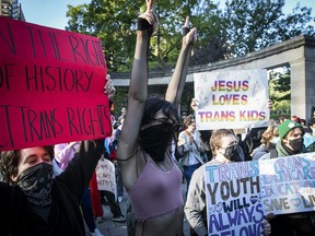 Counter-protesters show their support for trans youth in front of McGill Univerisity's Roddick Gates in Montreal on Wednesday, Sept. 20, 2023.