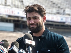 An emotional Laurent Duvernay-Tardif stands behind a group of microphones Thursday at Molson Stadium.