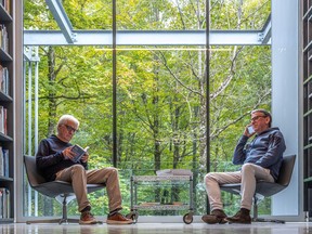 Seated, art lovers Bernard Landriault, left, and Michel Paradis appear suspended in a treehouse at the Grantham Foundation for the Arts and the Environment, a building in St-Edmond-de-Grantham designed by architect Pierre Thibault.