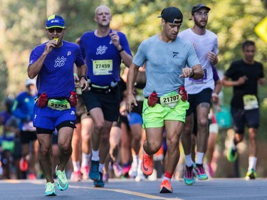 People offer encouragement near La Fontaine Park during the Montreal Marathon on Sunday, Sept. 24, 2023.