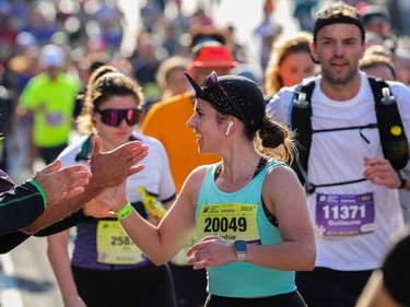A runner receives encouragement during the Montreal Marathon on Sunday, Sept. 24, 2023.