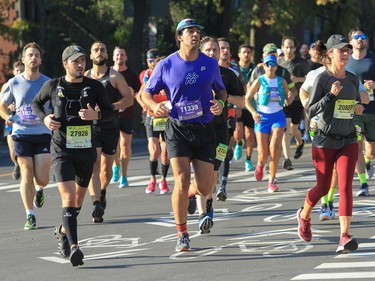 People run near La Fontaine Park during the Montreal Marathon on Sunday, Sept. 24, 2023.