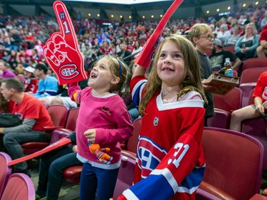 Friends Juliette Charbonneau, right, and Isabelle Etcovitch cheer as the Canadiens take to the ice for the team's annual Red & White intrasquad game in Montreal on Sunday, Sept. 24, 2023.