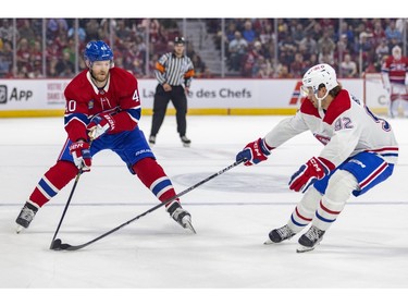 Defenceman Nicolas Beaudin, right, knocks the puck away from Joel Armia during the Canadiens Red & White intrasquad game in Montreal on Sunday, Sept. 24, 2023.