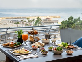 A luxurious breakfast spread overlooking the Mediterranean Sea.
