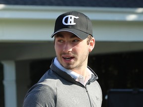 Canadiens' Kirby Dach sports a black Candiens hat with the CH logo on it and a grey sweatshirt at the team's annual golf tournament in Laval on Monday.