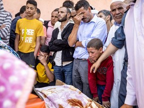 People mourn in front of the body of a victim killed in an earthquake in Moulay Brahim, Al Haouz province, on Sunday, Sept. 9, 2023. Morocco's deadliest earthquake in decades has killed at least 820 people, officials said on Sunday, causing widespread damage and sending terrified residents and tourists scrambling to safety in the middle of the night.