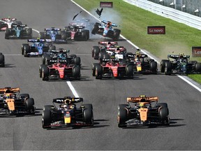 Red Bull Racing's Dutch driver Max Verstappen (front, centre) and McLaren's British driver Lando Norris (front, right) drive ahead of McLaren's Australian driver Oscar Piastri (front, left as Williams' Thai driver Alexander Albon (back, right) collides with Alfa Romeo's Finnish driver Valtteri Bottas (back, second right) at the start of the Formula One Japanese Grand Prix at the Suzuka circuit, Mie prefecture on Sunday, Sept. 24, 2023.