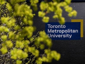 A sign for Toronto Metropolitan University behind some foliage
