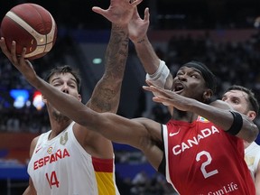 Canada guard Shai Gilgeous-Alexander (2) shoots against Spain centre Willy Hernangomez (14) during the Basketball World Cup second round match between Spain and Canada at the Indonesia Arena stadium in Jakarta, Indonesia, on Sunday, Sept. 3, 2023.