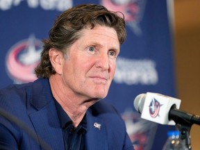Mike Babcock, sporting a blue jacket and black shirt, is seen at his introductory press conference in Columbus on July 1.