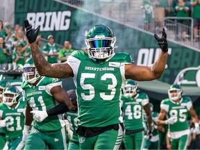 Saskatchewan Roughriders linebacker Darnell Sankey, clad in the Riders' green uniforms, runs out onto the field with his teammates during a game in 2022.
