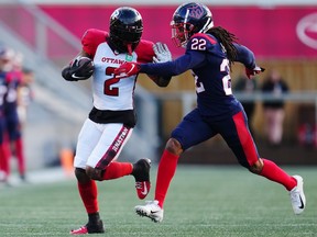 Ottawa Redblacks wide receiver Justin Hardy (2) protects the ball from Montreal Alouettes defensive back Dionté Ruffin (22)in CFL pre-season football action in Ottawa on May 26, 2023.