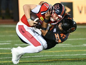 Alouettes quarterback Cody Fajardo (7) is sacked by B.C. Lions' Sione Teuhema (47) during second half CFL football action in Montreal on Saturday, Sept. 2, 2023.