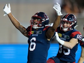 Alouettes wide-receiver Tyson Philpot, in a dar-blue jersey and dark-blue helmet, celebrates his touchdown against Toronto last week.