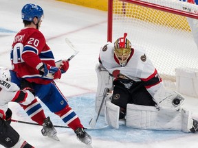 Senators goalie Joonas Korpisalo goes down in the butterfly and makes a nice glove save with his left hand on Canadiens' Juraj Slafkovsky, who was perched in front of Ottawa's net.