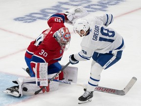 Canadiens goalie Cayden Primeau shoots out his right pad to block a shot by the Leafs' Noah Gregor.