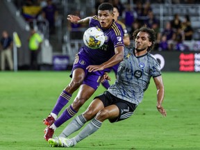 Orlando City midfielder Wilder Cartagena, left, and CF Montréal midfielder Ahmed Hamdi vie for the ball during the first half of an MLS soccer match on Saturday, Sept. 30, 2023, in Orlando, Fla.