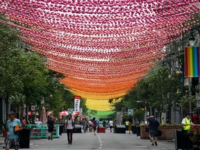 Art installation known as 50 Shades of Gay by designer Claude Cormier hangs over Ste-Catherine St. in Montreal's Gay Village on July 24, 2018.