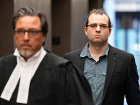 Gabriel Sohier Chaput follows his lawyer as he arrives for a sentencing hearing in Montreal, on July 12, 2023. Sohier Chaput was found guilty in January of promoting hatred against Jews in connection with an article he wrote for the neo-Nazi website the Daily Stormer.