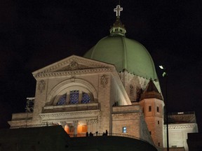 People stand outside the Saint Joseph Oratory in Montreal at night