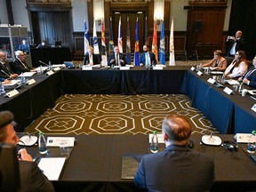 A large room with flags in the background is seen in this photo