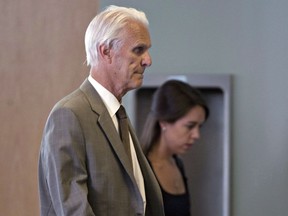 Quebec's Court of Appeal has overturned a stay of proceedings granted to retired Quebec judge Jacques Delisle, whose conviction for fatally shooting his wife in 2012 was reversed by the federal justice minister. Delisle, left, walks into court with his granddaughter Anne Sophie Morency, Thursday, June 14, 2012 in Quebec City.