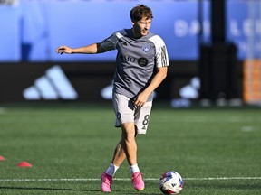 midfielder Matko Miljevic, in a grey shirt and white shorts, is seen warming up on the field before a CF Montréal game this season.