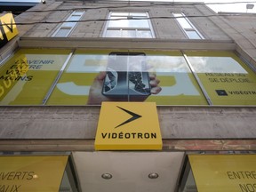 The front of a Vidéotron retail store in Montreal with the yellow and black logo at the centre.