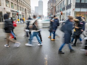 Street scene show pedestrians crossing Ste-Catherine St. in Montreal.