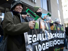 A small group of protesters from FRAPRU took to the street in front of the Sheraton Centre on March 24, 2023, to protest for more social housing while Quebec Finance Minister Eric Girard was addressing the Montreal Board of Trade.