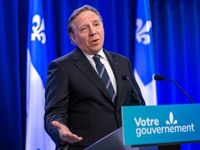 Premier François Legault gestures while addressing reporters at the National Assembly in Quebec city.
