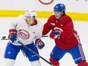 Defenceman David Reinbacher, right, pushes Jared Davidson during Canadiens rookie camp in Brossard last month.