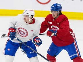 Defenceman David Reinbacher, in a red jersey on the right side of the photo, is seen pushing Jared Davidson during Canadiens rookie camp in Brossard last month.
