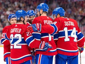 Team Red celebrates a goal with a group hug during the Canadiens' annual Red vs. White scrimmage at the Bell Centre last month.