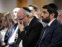 A man is overcome by emotion during a vigil at Montreal's Gelber Conference Centre Monday, October 9, 2023, held in response to the deadly surprise attack in Israel by Hamas militants.