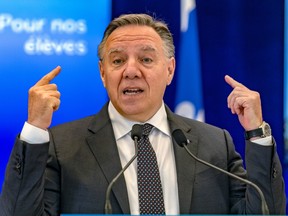 Quebec Premier François Legault addresses reporters from a lectern.