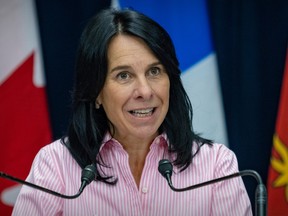 A closeup of Valérie Plante, wearing a pink shirt, during a press conference.