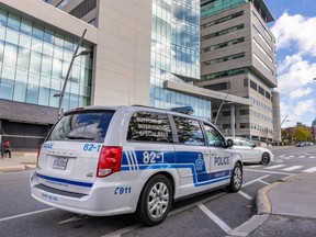A police vehicle is parked across the street from the Jewish General Hospital in Montreal on Friday, Oct. 13, 2023.