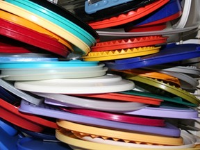 A drawerful of colourful plastic lids.