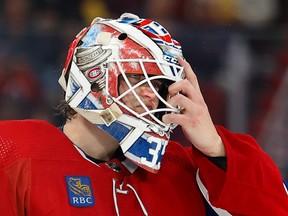 Canadiens goaltender Sam Montembeault pulls off his facemask.