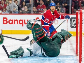 Minnesota Wild goalie Marc-André Fleuryis seen on his butt with his pads in the air after making an acrobatic save on Canadiens' Johnathan Kovacevic, seen int eh bckground, on Tuesday night.