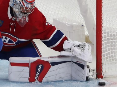 Montreal Canadiens goaltender Cayden Primeau looks at a puck right next to the goal post