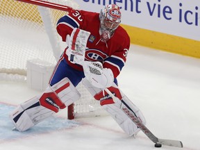 Canadiens goalie Cayden Primeau handles the puck on his stick to the left of the Montreal net.